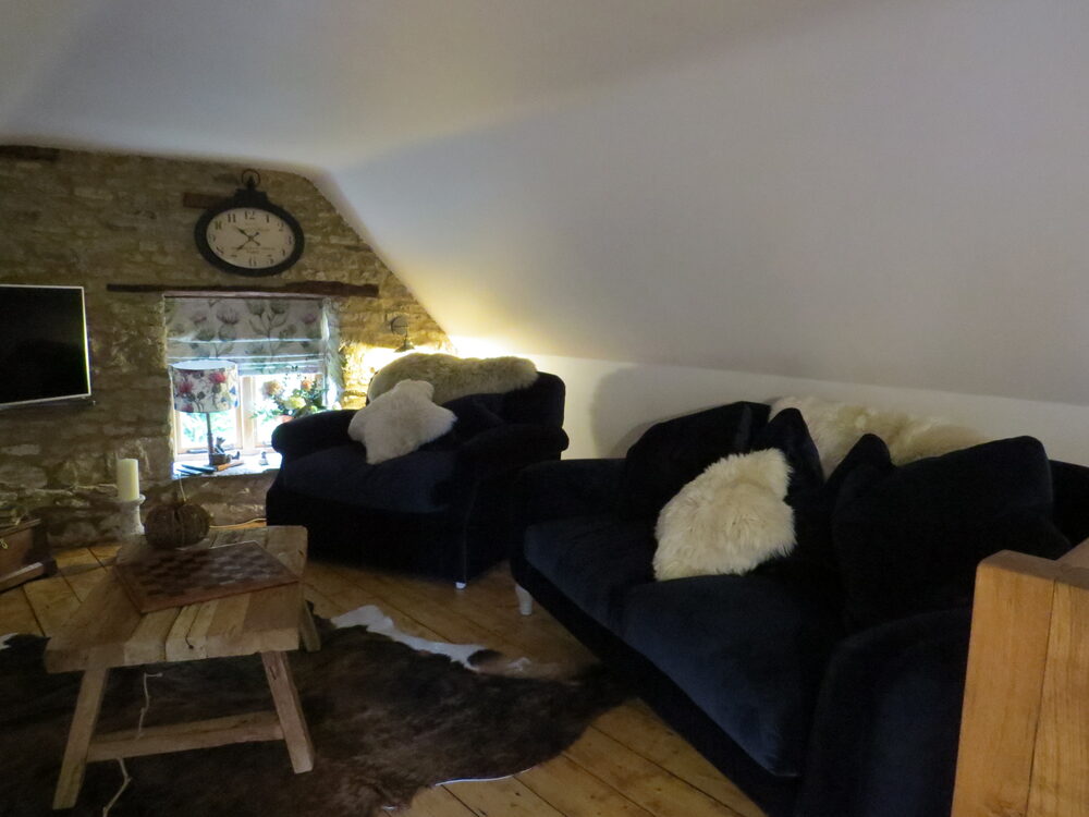 Upstairs loft sitting room with velvet sofas
